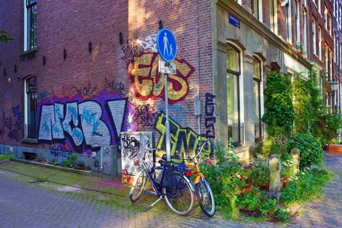  : Bicycles parked in the street with grafitti in Amsterdam, Holland