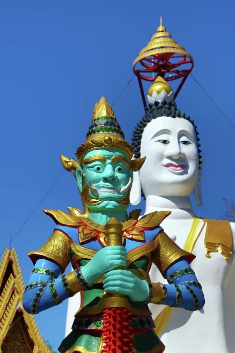  : Big white Buddha statue and temple guardian at Wat Ko Kaew Pitsadan Temple, Koh Samet, Thailand