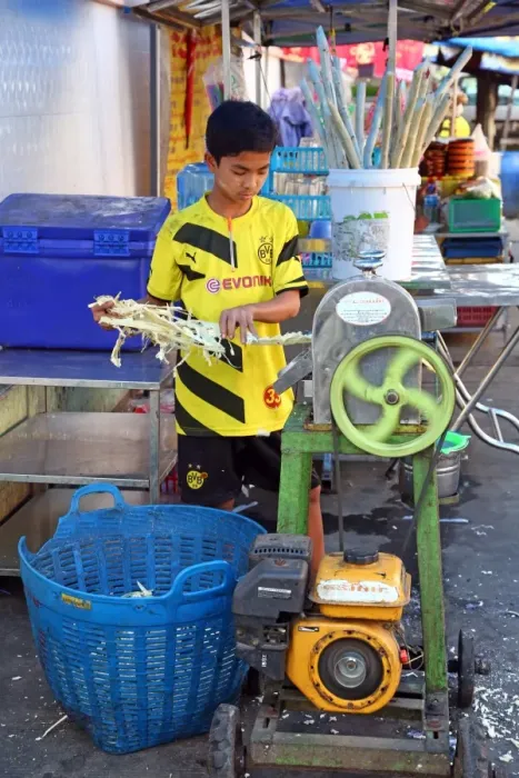  : Boy making Durian juice in the street by squeezing the fruit, Yangon, Myanmar