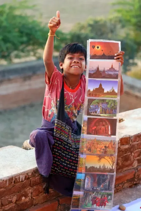  : Boy selling postcards to tourists at North Guni Temple Pagoda on the Plain of Bagan