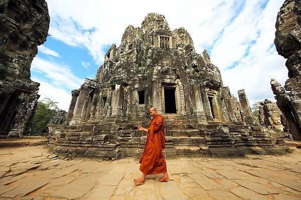 Buddhist monk in the ruins of the Bayon Khmer Temple, Angkor Thom, Siem Reap, Cambodia