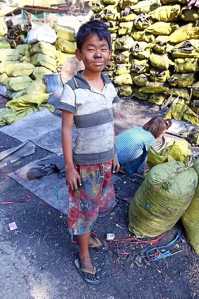 Children making and collecting charcoal in Amarapura, Mandalay, Myanmar (Burma)