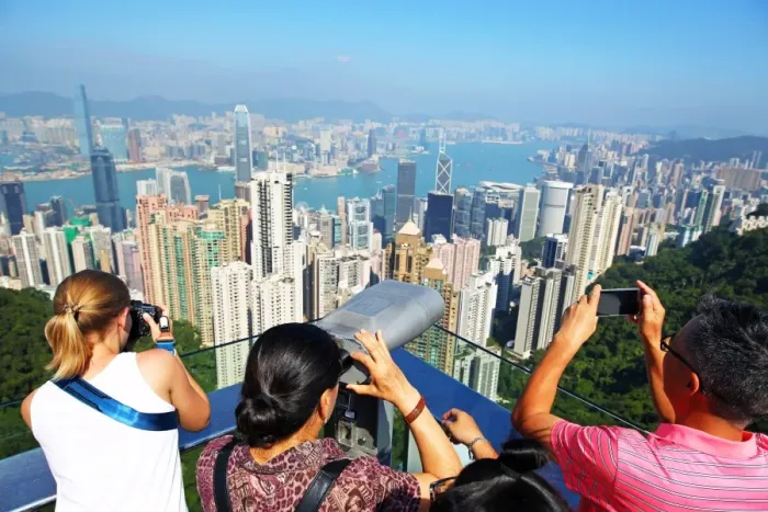  : The city skyline of Hong Kong from the Victoria Peak with tourists on the Sky Terrace