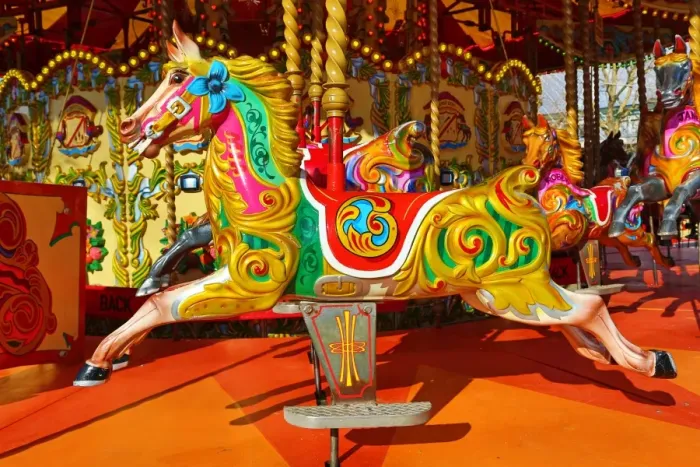  : Colourful painted horses on a fairground carousel