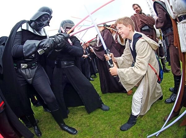 Darth Vader from Star Wars takes on a young Jedi Knight in a light sabre battle at