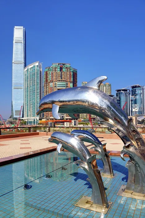 : Dolphin Sunset statues at Gateway Promenade in Tsim Sha Tsui with the ICC Tower and Union Square development behind, Hong Kong, China