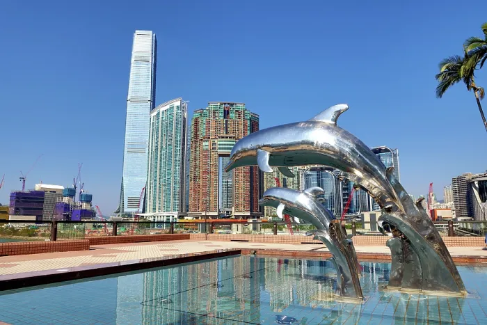  : Dolphin Sunset statues at Gateway Promenade in Tsim Sha Tsui with the ICC Tower and Union Square development behind, Hong Kong, China