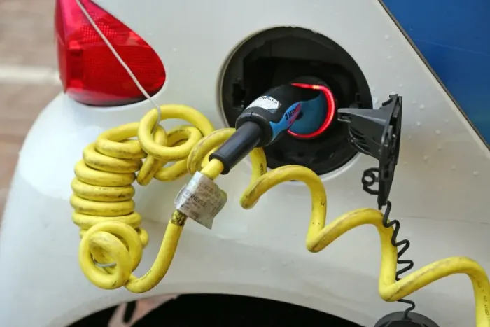 : Electric car charging at a charging station in the street in Amsterdam, Holland