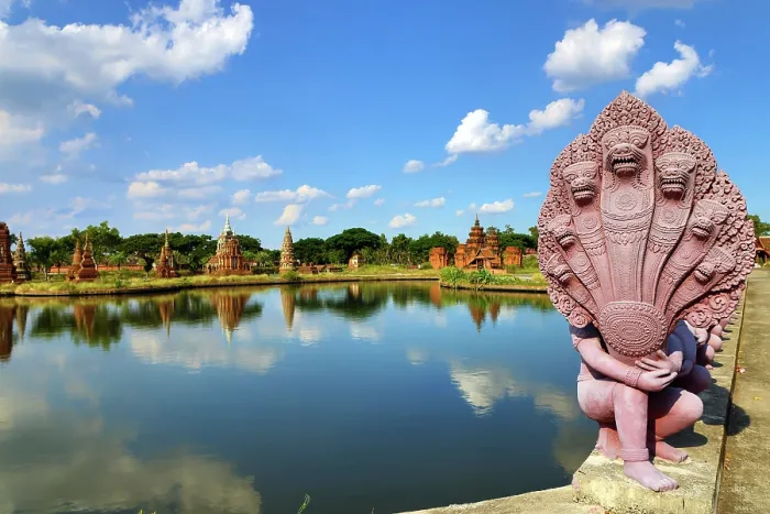  : The Garden of Sacred Stupa and a Naga Statue at Muang Boran, The Ancient City, historical museum of reproductions of famous Thai buildings, Bangkok, Thailand