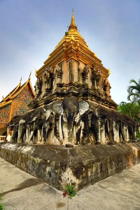  : Gold chedi decorated with elephants in Wat Chiang Man Temple in Chiang Mai, Thailand