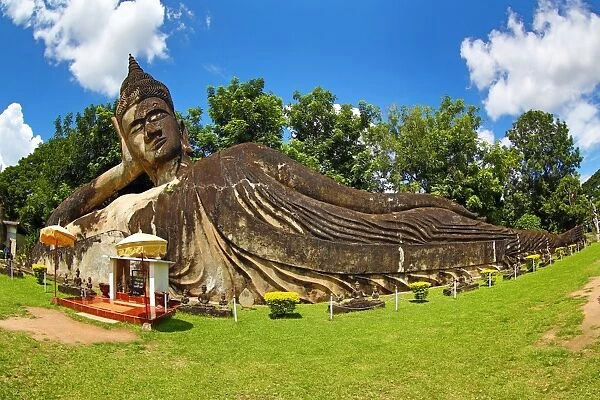 Grave markers and gold reclining sleeping Buddha statue at Wat Si Saket near Pha That Luang Temple