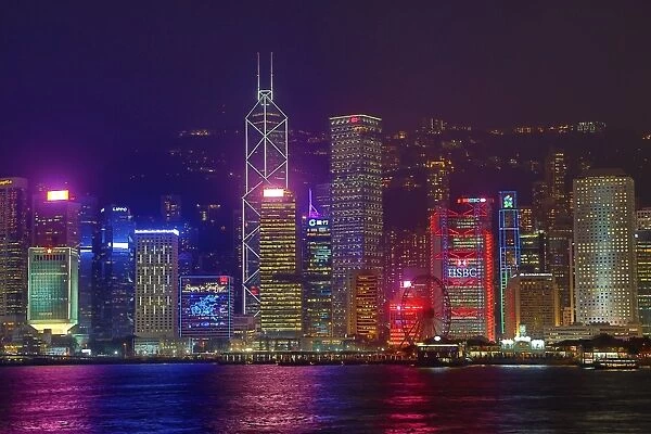 Lights of the city skyline of Central across Victoria Harbour at night in Hong Kong
