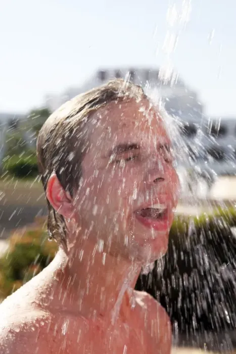  : Man taking a shower on the beach