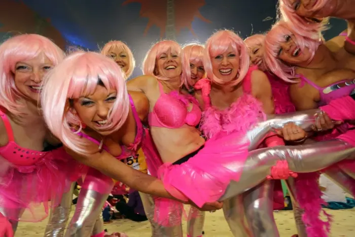  : Participants at the Moonwalk charity marathon walk with decorated bras, London