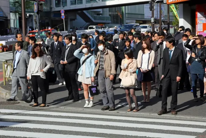  : People waiting at a pedestrain crossing to cross a road in Shinjuku, Tokyo, Japan