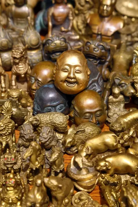  : Pile of brass figures including laughing Buddha head in the Old City, Shanghai, China