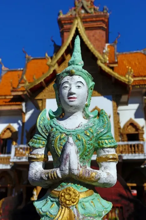  : Praying statue in front of the ordination hall at Wat Buppharam Temple in Chiang Mai