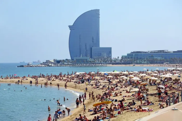  : Scene of holiday crowds on the crowded beach and the W hotel, Barcelona, Spain