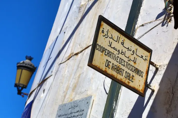 : Shop sign and street light in French and Arabic in the Media in Rabat, Morocco : Shop sign and street light in French and Arabic in the Media in Rabat, Morocco