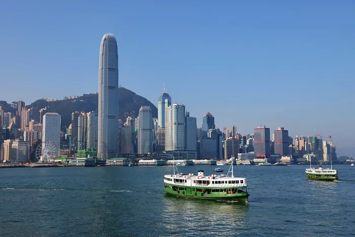  : Two Star Ferries crossing Victoria Harbour with the city skyline in Hong Kong, China