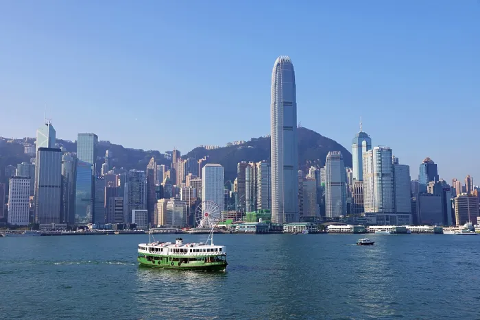  : Star Ferry crossing Victoria Harbour with the city skyline in Hong Kong, China