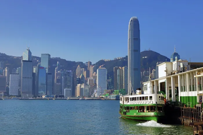  : Star Ferry leaving Tsim Tsa Shui terminal and crossing Victoria Harbour with the city skyline in Hong Kong, China