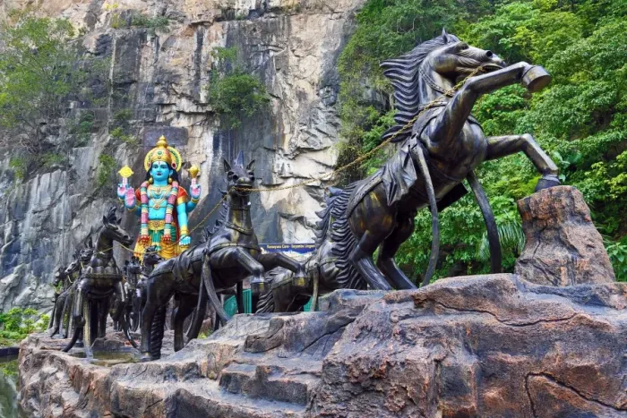  : Statue of Krishna with a horse drawn chariot at the Ramayana Cave at the Batu Caves, a Hindu shrine in Kuala Lumpur, Malaysia