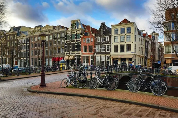 : Street scene with bicycles on a bridge over a canal in Herengracht in Amsterdam, Holland : Street scene with bicycles on a bridge over a canal in Herengracht in Amsterdam, Holland