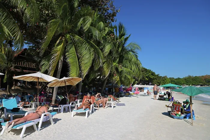  : Tourists sunbathing on Sai Kaew beach on Koh Samet island in Thailand