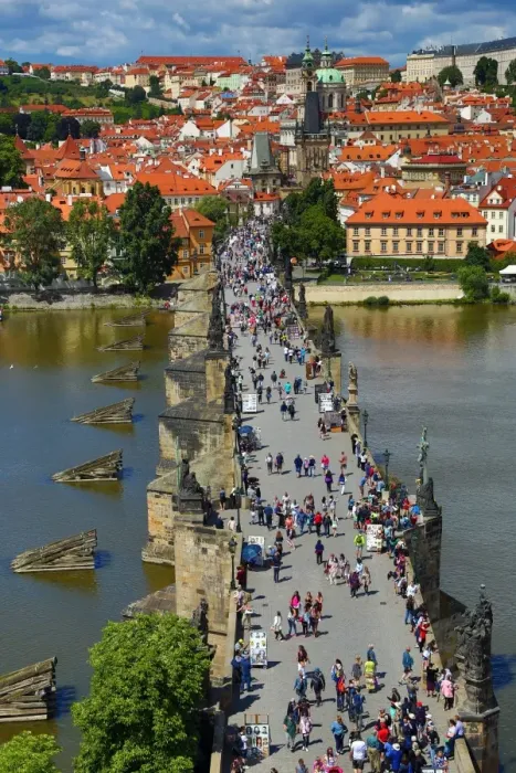  : Tourists walking over the Charles Bridge over the Vltava River in Prague, Czech Republic