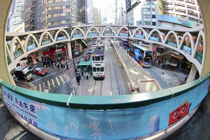  : Traditional Hong Kong electric tram at Yee Wo Street circular pedestrian bridge in Causeway Bay, Hong Kong, China