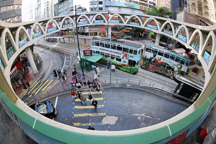  : Traditional Hong Kong electric tram at Yee Wo Street circular pedestrian bridge in Causeway Bay, Hong Kong, China