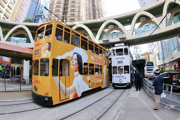 : Traditional Hong Kong electric tram at Yee Wo Street circular pedestrian bridge in Causeway Bay, Hong Kong, China : Traditional Hong Kong electric tram at Yee Wo Street circular pedestrian bridge in Causeway Bay, Hong Kong, China