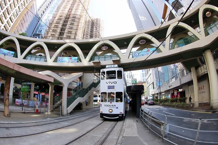  : Traditional Hong Kong electric tram at Yee Wo Street circular pedestrian bridge in Causeway Bay, Hong Kong, China