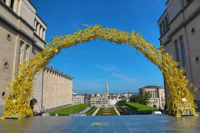  : Yellow Arch of bicycles at the Mont des Arts Gardens and Tower of the Town Hall, Brussels