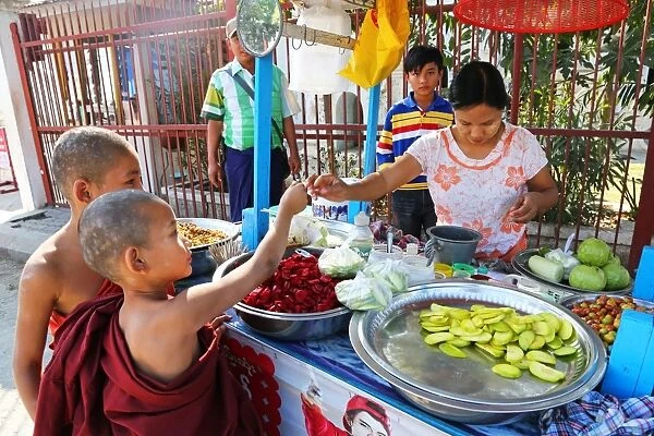 Young monks at the Atum Ash Monastery buying food from a street vendor, Mandalay