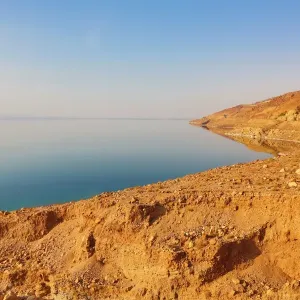 Barren shoreline and salt water of the Dead Sea, Jordan