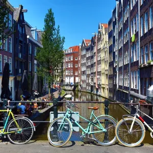 Bicycles on a bridge on the Oudezijds Achterburgwal canal and houses in Amsterdam