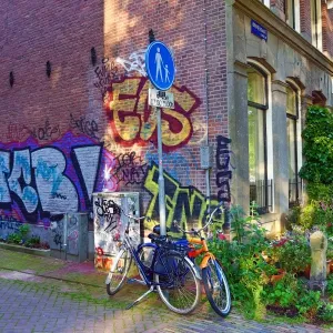 Bicycles parked in the street with grafitti in Amsterdam, Holland
