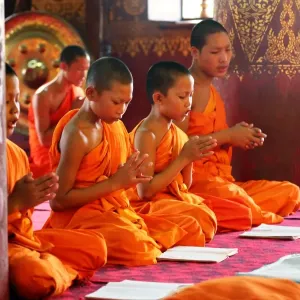 Buddhist monks at worship in Wat Sen temple in Luang Prabang, Laos