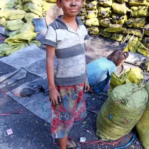Children making and collecting charcoal in Amarapura, Mandalay, Myanmar (Burma)