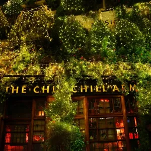 Churchill Arms Pub covered in Christmas Trees in Kensington, London