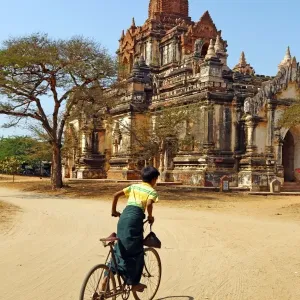Cyclist at Thatthe Mokgo Hpaya Pagoda in Nuang U, Bagan, Myanmar (Burma)