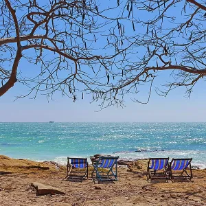 Deckchairs on Koh Samet beach overlooking the sea on Koh Samet island, Thailand