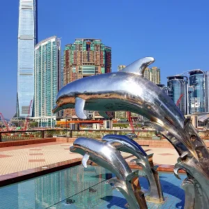 Dolphin Sunset statues at Gateway Promenade in Tsim Sha Tsui with the ICC Tower and Union Square development behind, Hong Kong, China Dolphin Sunset statues at Gateway Promenade in Tsim Sha Tsui with the ICC Tower and Union Square development behind, Hong Kong, China