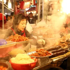 Food stalls at night at Gwangjang Market in Jongro, Seoul, Korea