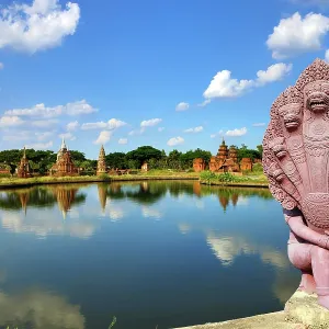 The Garden of Sacred Stupa and a Naga Statue at Muang Boran, The Ancient City, historical museum of reproductions of famous Thai buildings, Bangkok, Thailand