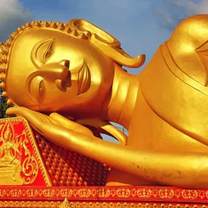 Giant gold reclining sleeping Buddha statue near Wat That Luang Temple, Vientiane, Laos Giant gold reclining sleeping Buddha statue near Wat That Luang Temple, Vientiane, Laos
