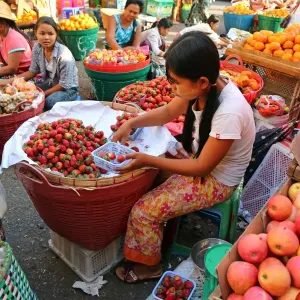 Girl selling strawberries in a street market, Yangon, Myanmar