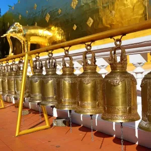 Gold elephant statue and bells on the chedi at Wat Phra Singh Temple in Chiang Mai